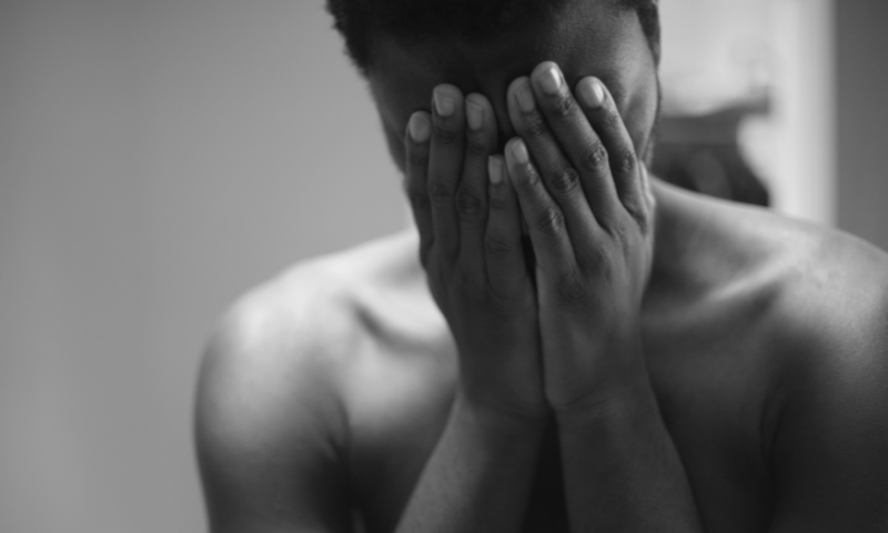 woman covering eyes