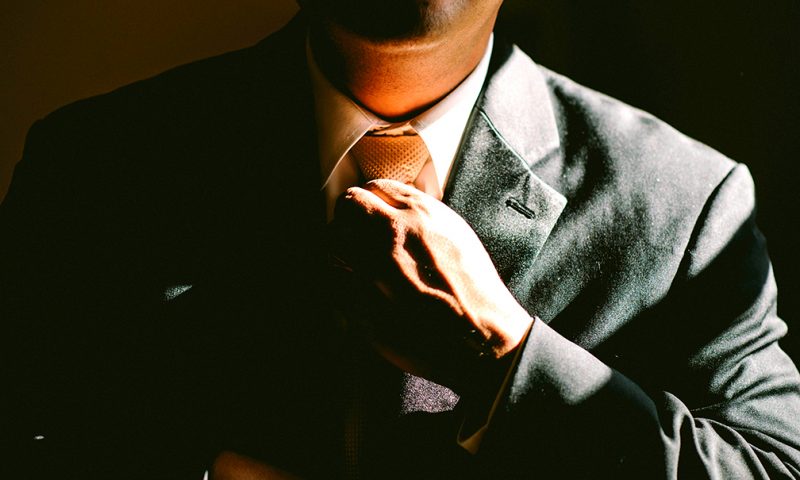 divorce and custody attorney straightens tie