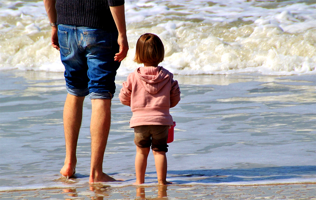 Step father and child get to know each other on the beach