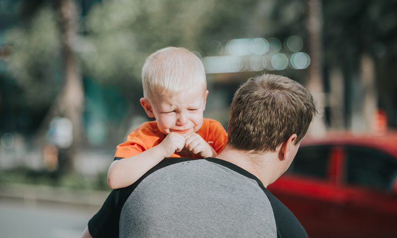 father with crying boy